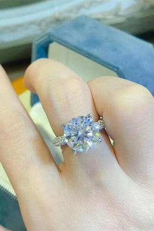 a close up of a person's hand with a ring on it