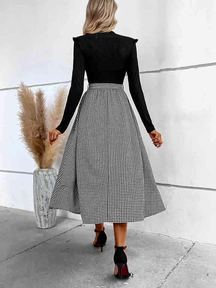 a woman in a black and white checkered skirt