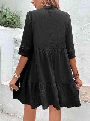 a woman wearing a black dress and sandals