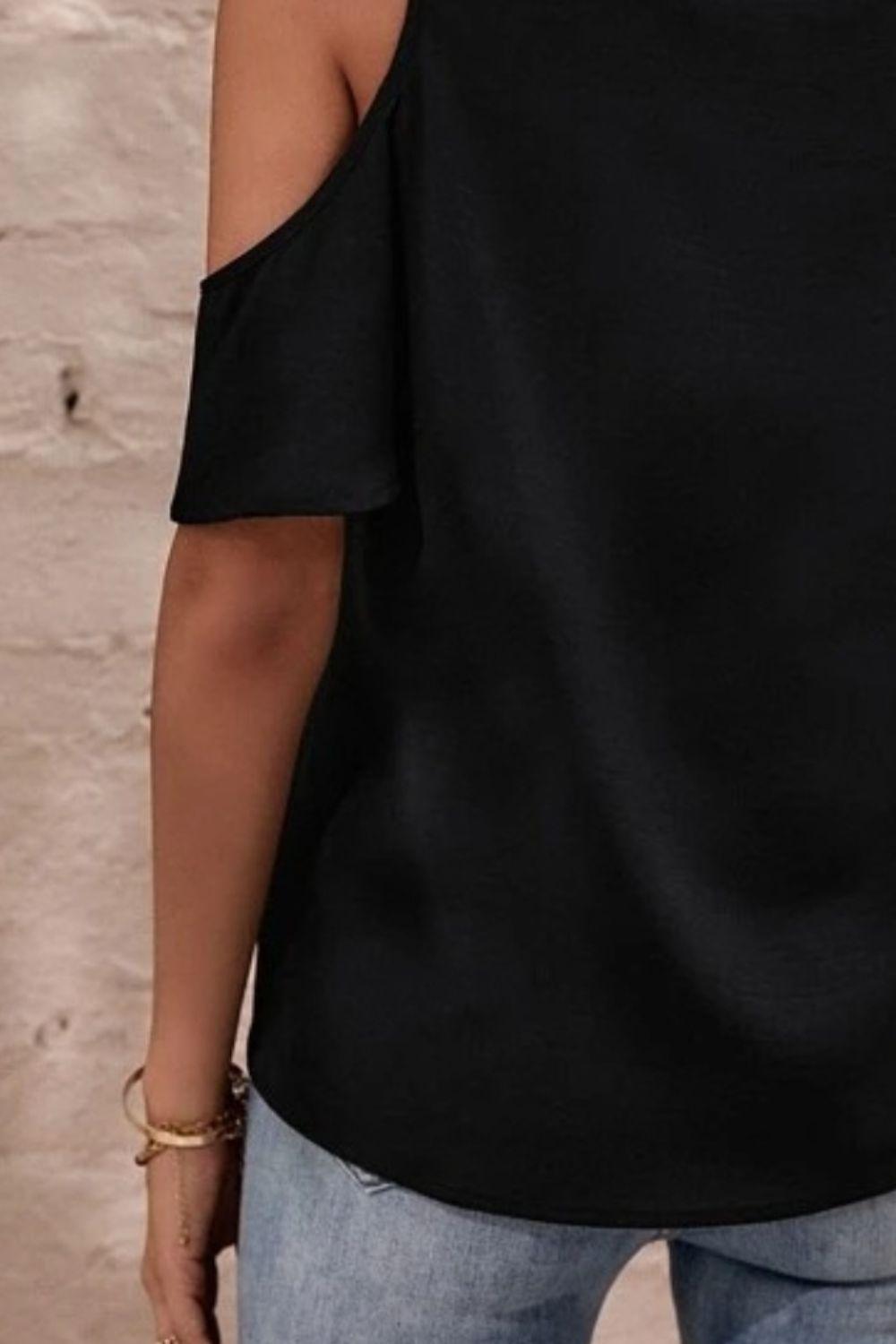 a woman wearing a black cold shoulder top