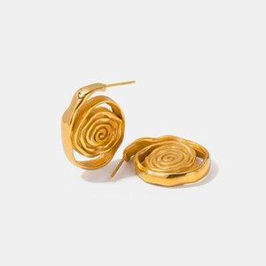 a pair of gold earrings on a white background