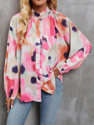 a woman wearing a pink and blue tie dye blouse