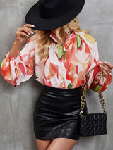 a woman wearing a black hat and a floral shirt