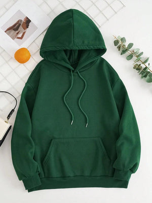 a green hoodie sitting on top of a white table