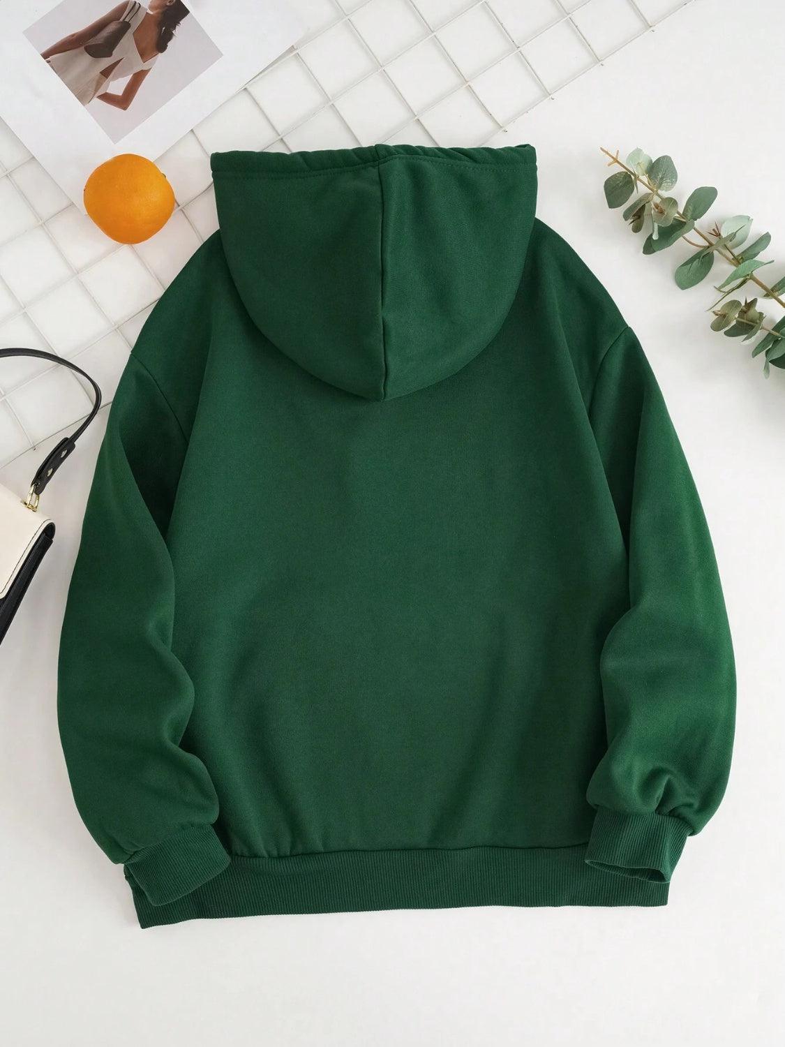 a green hoodie sitting on top of a white table