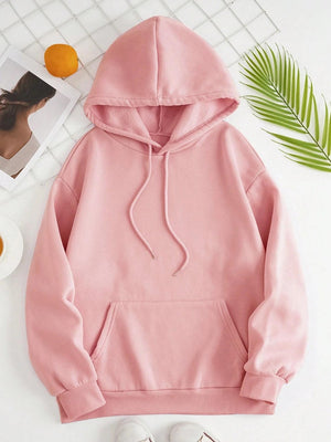 a pink hoodie sitting on top of a white table