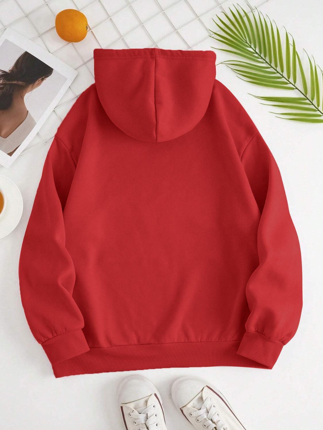a red hoodie with a pair of white shoes next to it