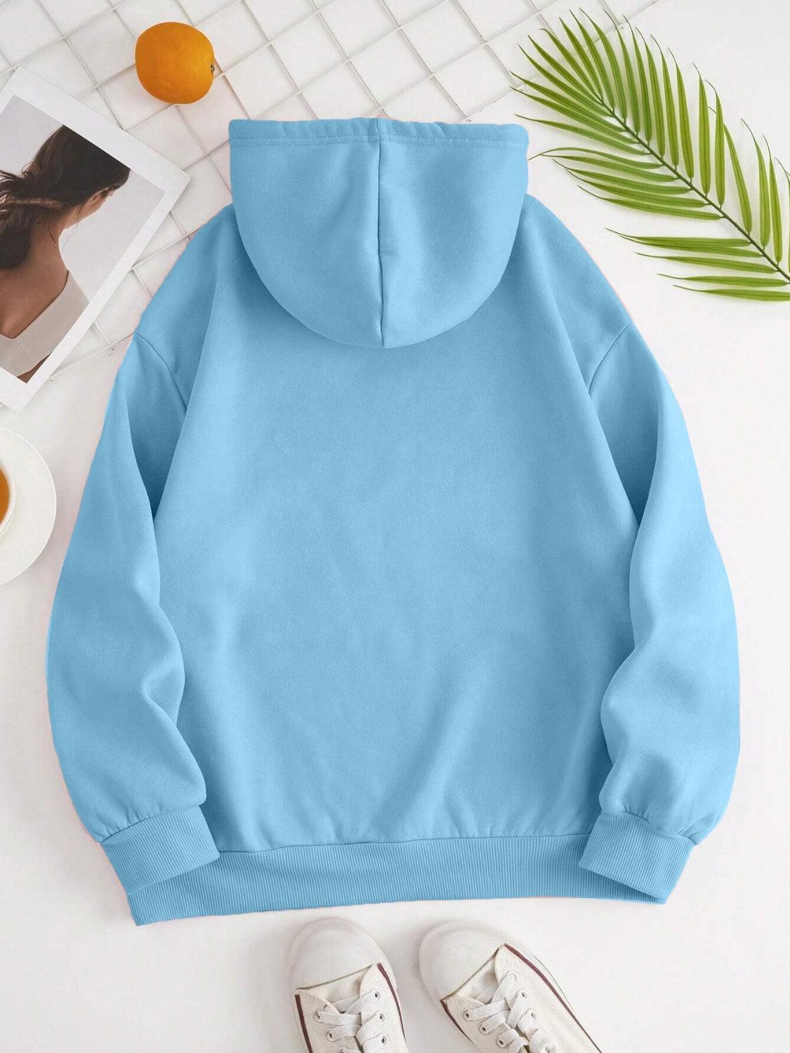 a blue hoodie with a pair of white shoes next to it