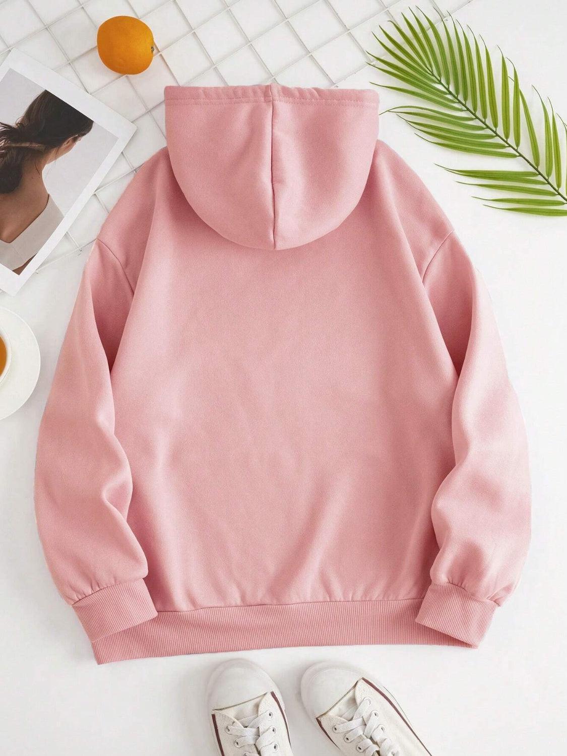 a pink hoodie with a pair of white shoes next to it