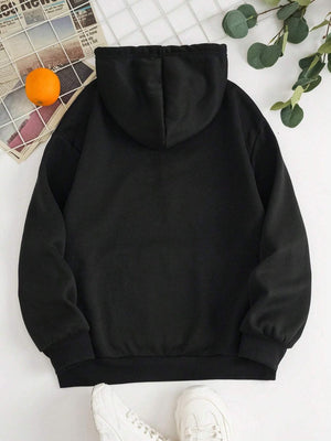 a black hoodie with a pair of white sneakers