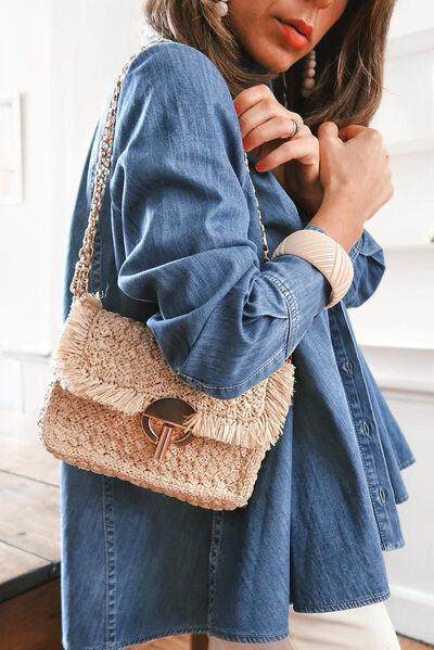 a woman in a denim jacket holding a straw bag