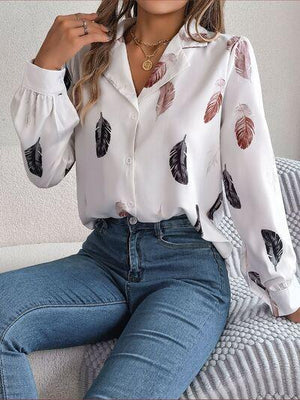 a woman sitting on a couch wearing a white shirt and jeans