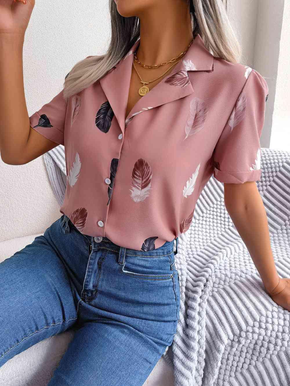 a woman sitting on a bed wearing a pink shirt and jeans