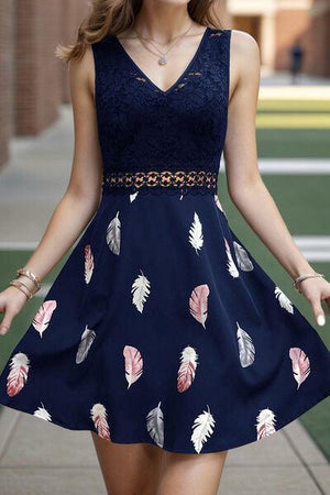 a woman in a dress walking down a sidewalk