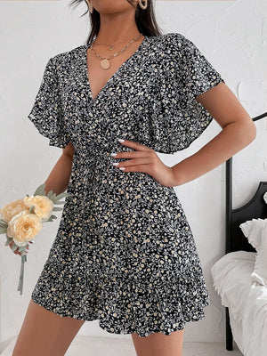 a woman in a black and white floral print dress