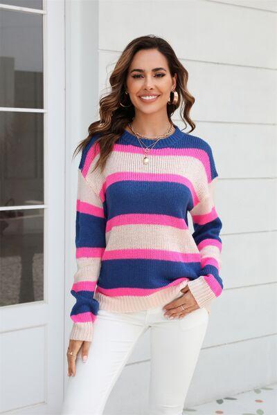 a woman wearing a pink and blue striped sweater