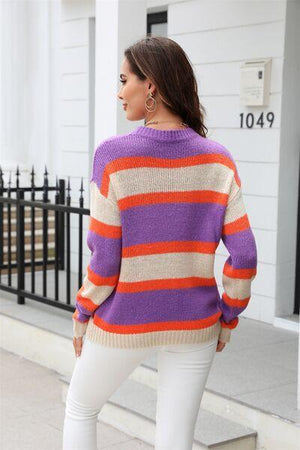 a woman wearing a purple and orange striped sweater