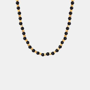a black beaded necklace with gold accents