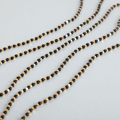 a long black and gold beaded necklace