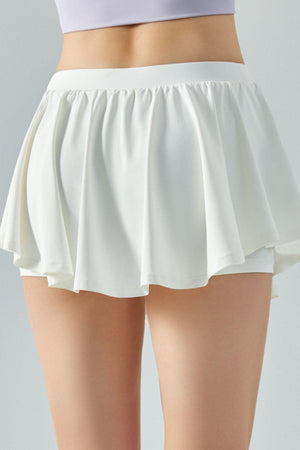 a close up of a person wearing a white skirt