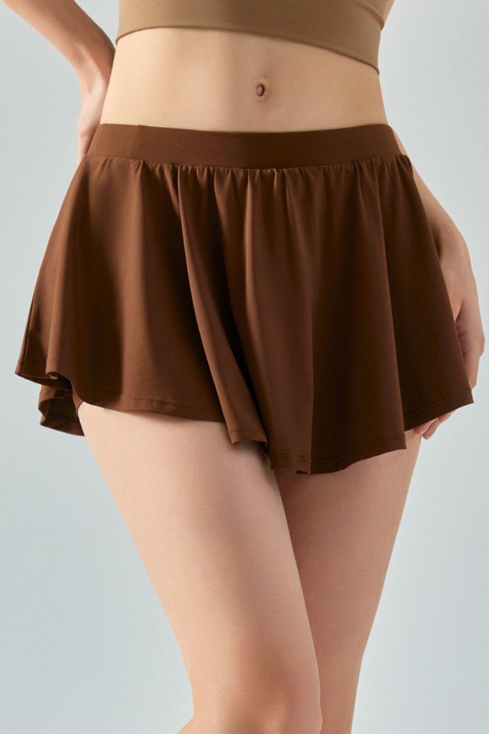 a woman wearing a brown skirt with a tan top