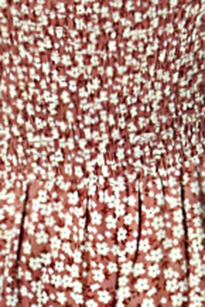 a close up of a red and white dress