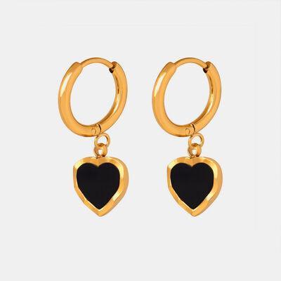 a pair of black and gold heart shaped earrings