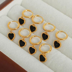 a bunch of black and gold rings in a box