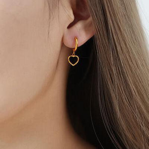 a close up of a person wearing a pair of earrings