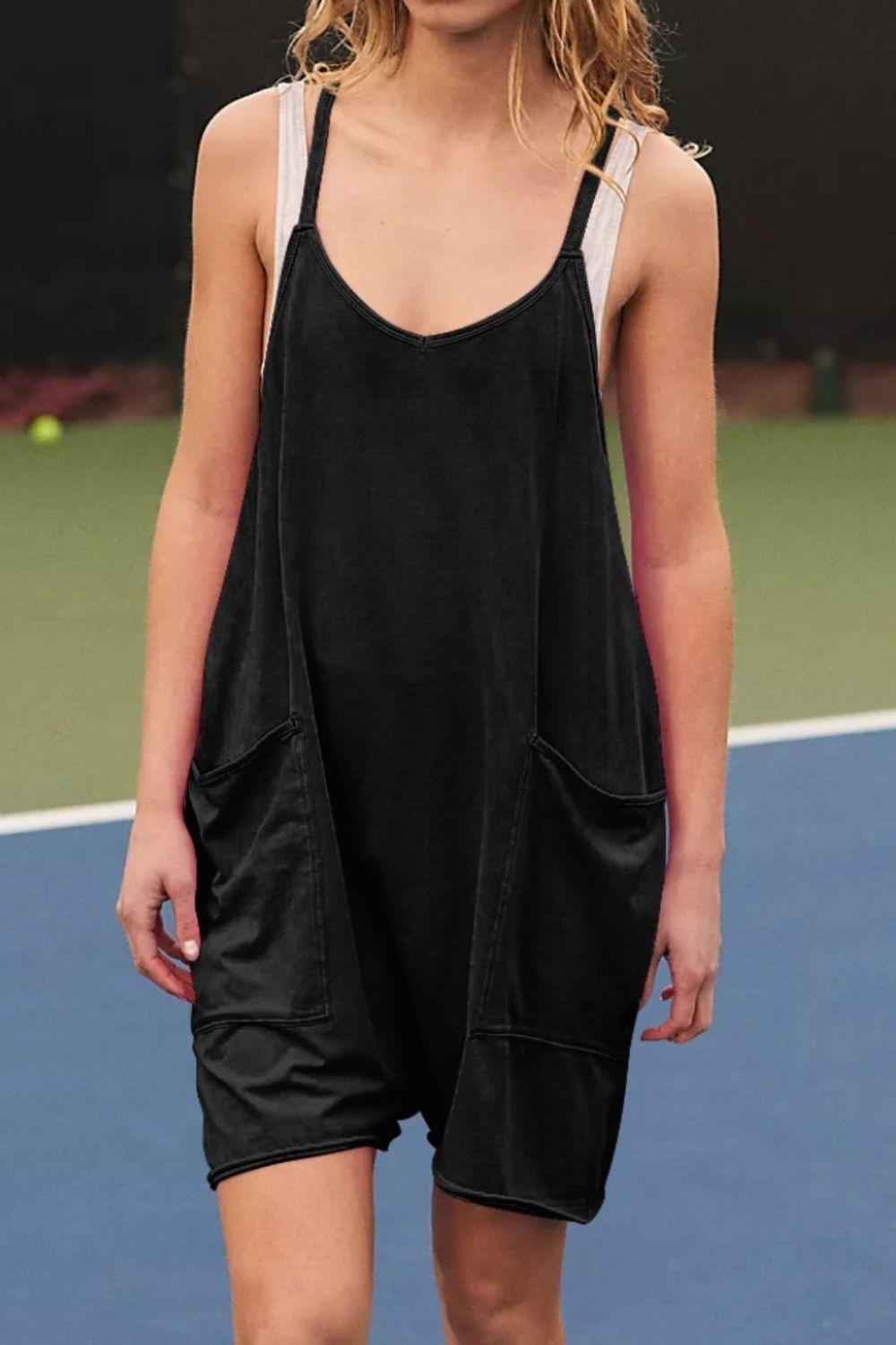 a woman standing on a tennis court holding a tennis racquet