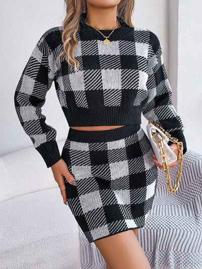 a woman wearing a black and white checkered sweater and skirt
