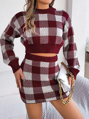 a woman wearing a red and white plaid sweater dress