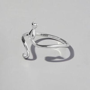 a silver ring on a white surface