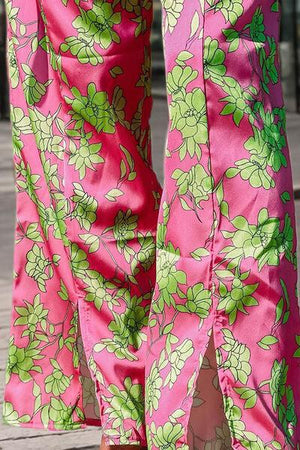 a close up of a person's legs wearing pink and green floral pants