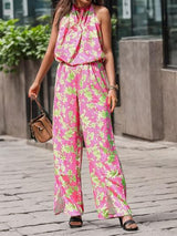 a woman wearing a pink and green jumpsuit