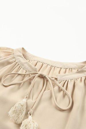 a close up of a dress with a tassel