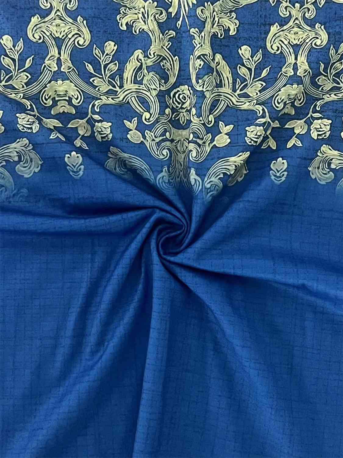 a close up of a blue cloth with a gold design