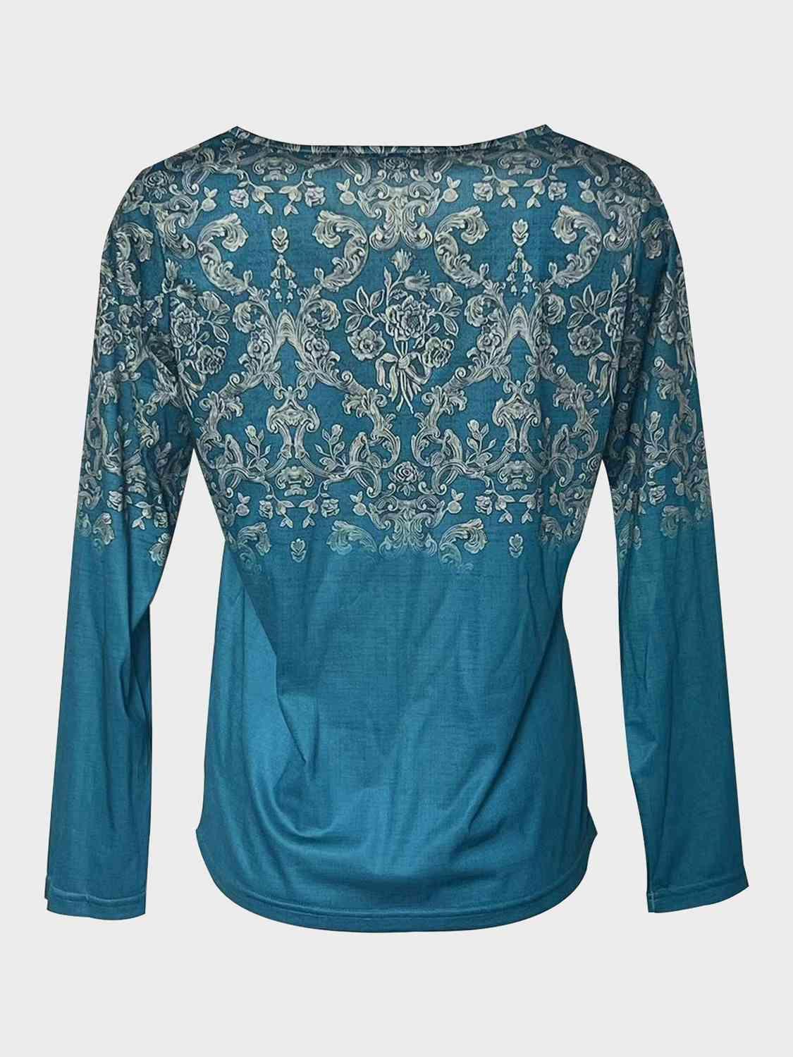 a blue top with a floral design on it