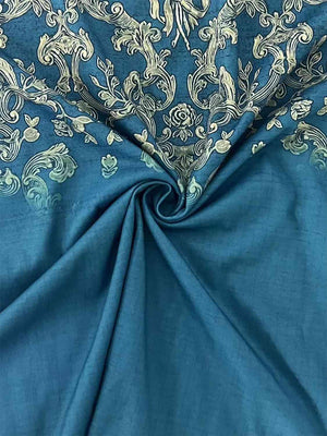 a close up of a blue fabric with white flowers on it