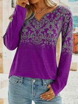 a woman wearing a purple top and jeans