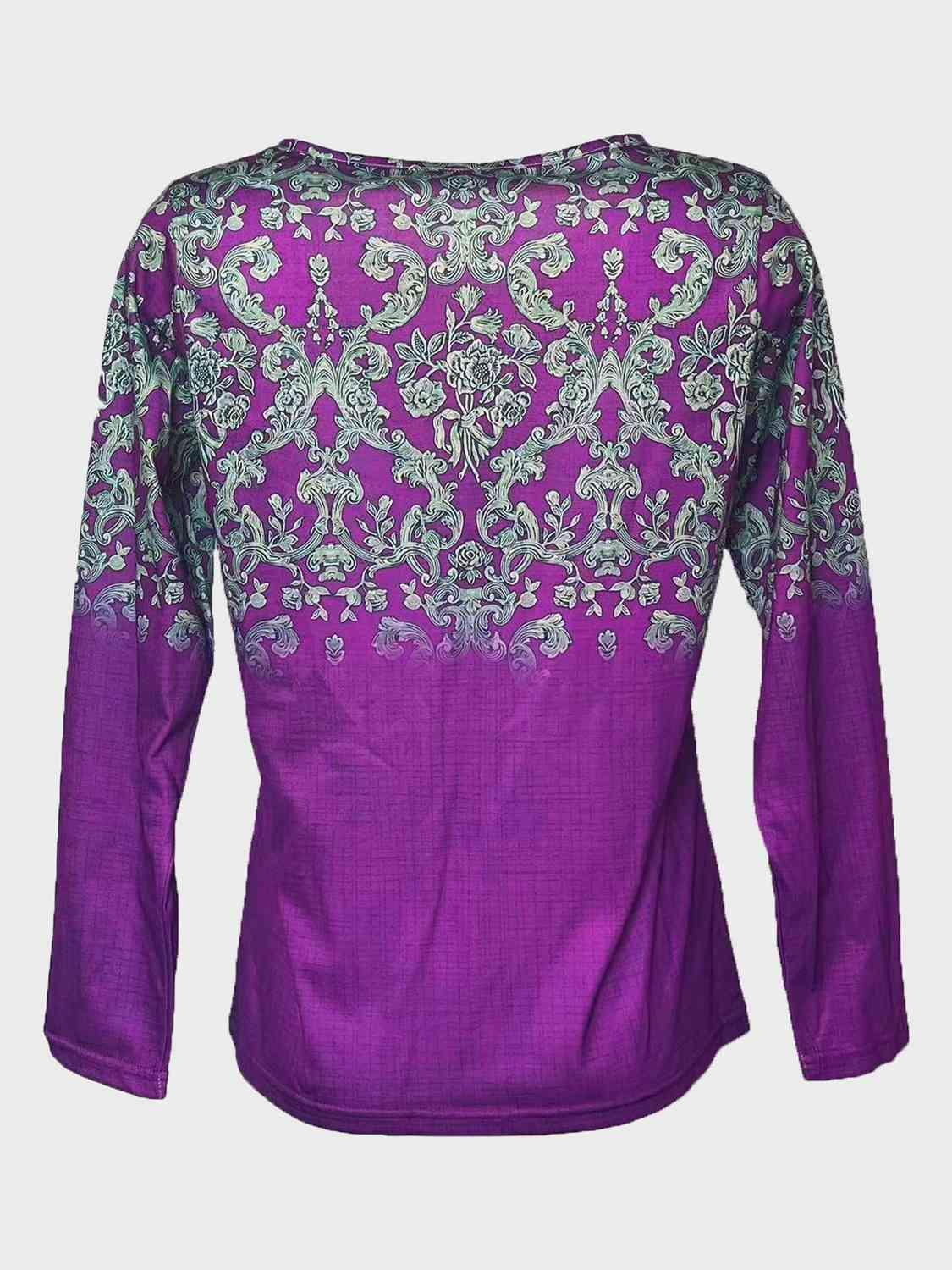 a purple top with a floral design on it