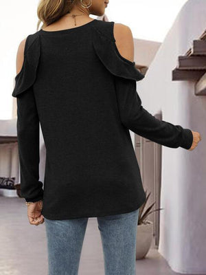 a woman wearing a black sweater and jeans