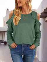 a woman wearing a green top and jeans