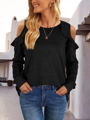 a woman wearing a black cold shoulder top