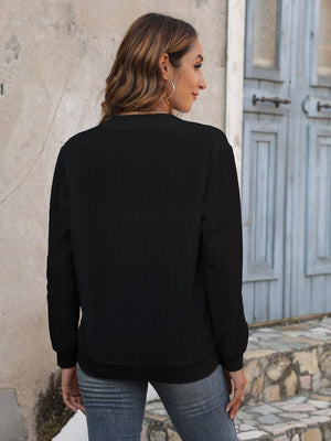 a woman wearing a black sweater and jeans