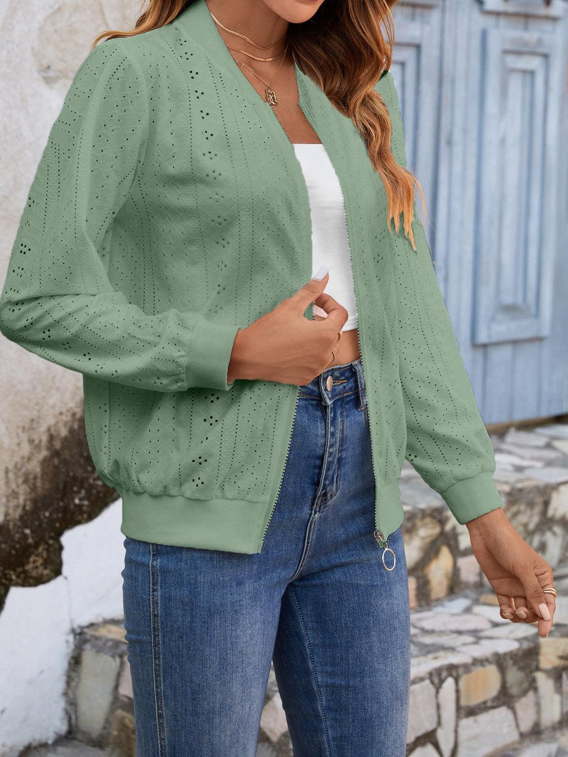 a woman wearing a green jacket and jeans