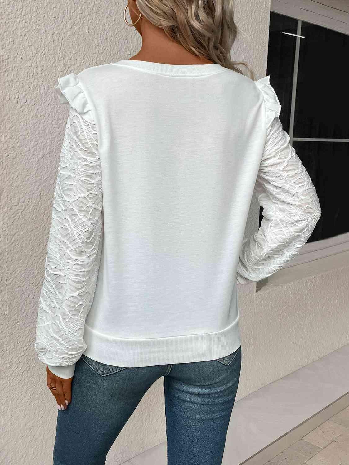 a woman wearing a white sweater and jeans