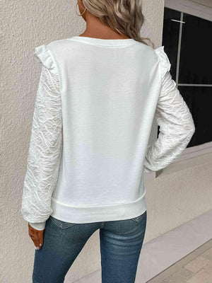 a woman wearing a white sweater and jeans