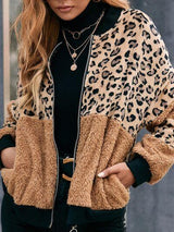 a woman wearing a leopard print jacket and black pants