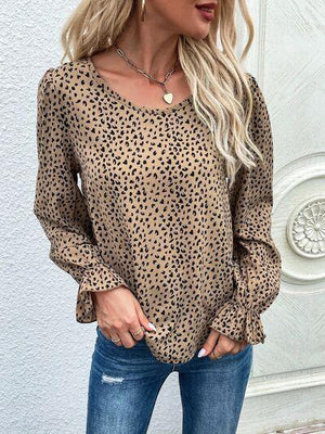 a woman wearing a leopard print top